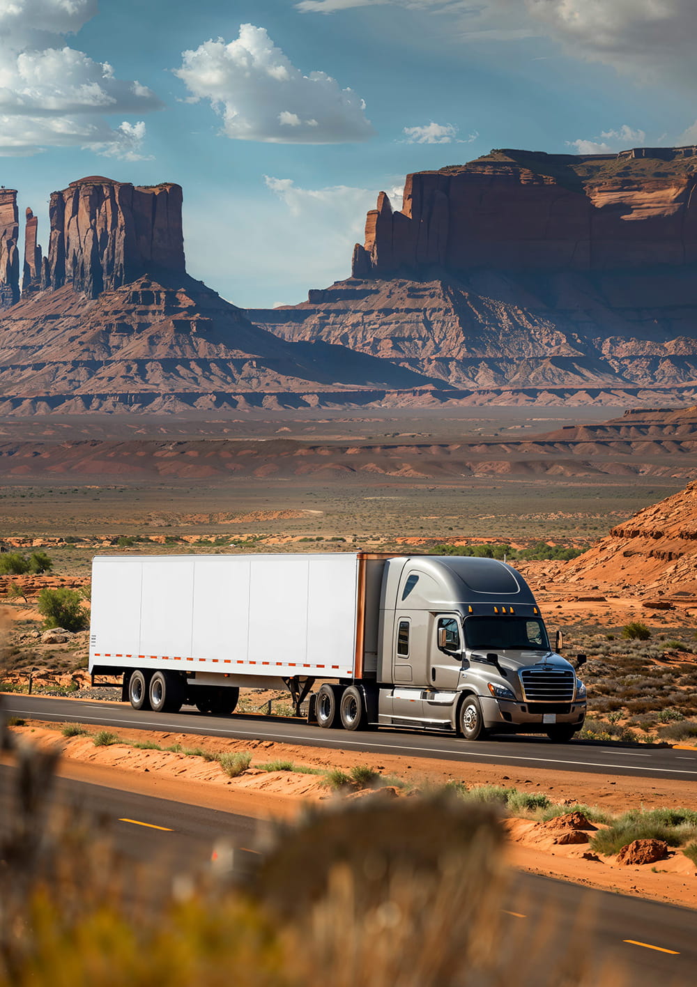 A late-model American sleeper-cab tractor on the open road